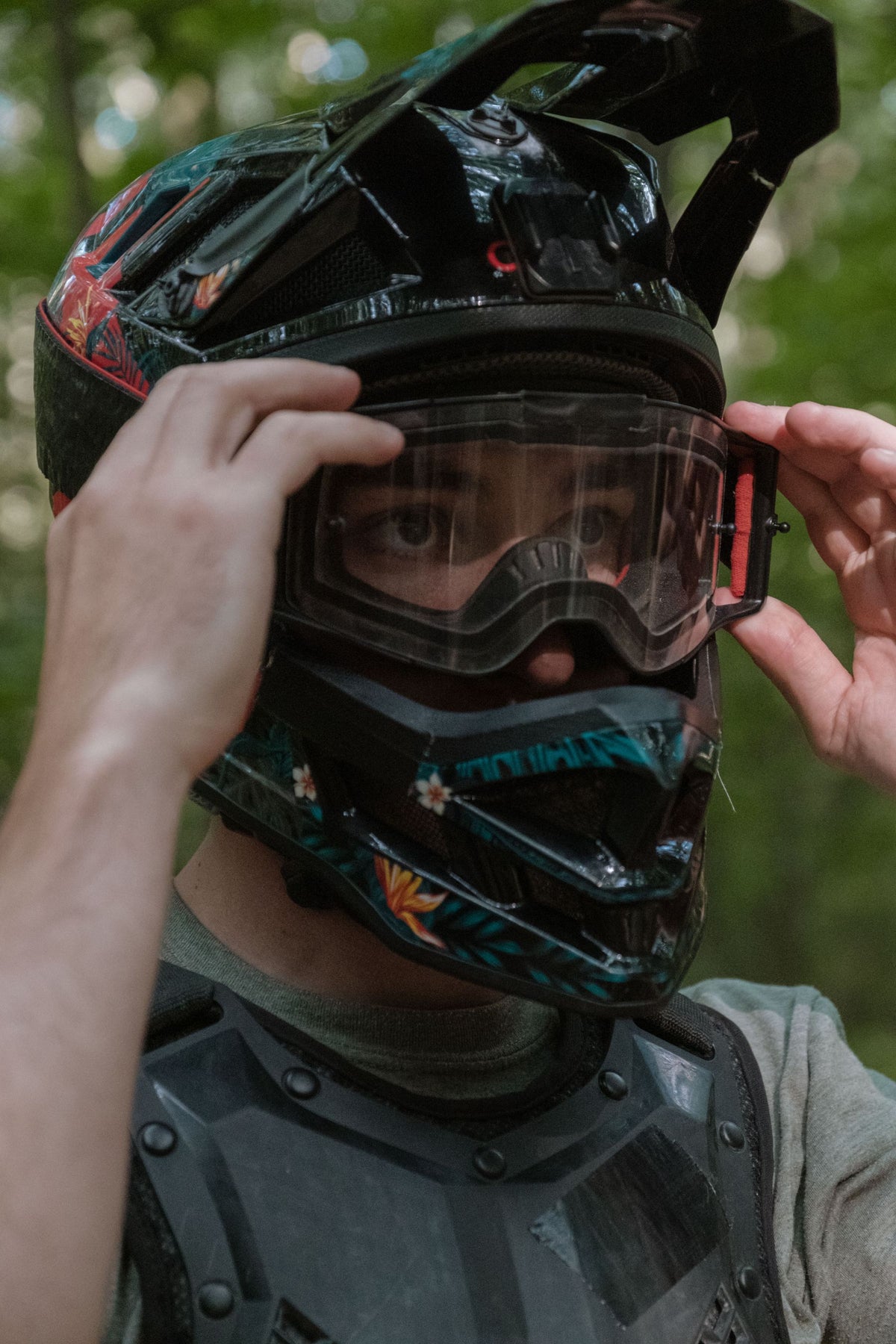 Rider pulling on goggles
